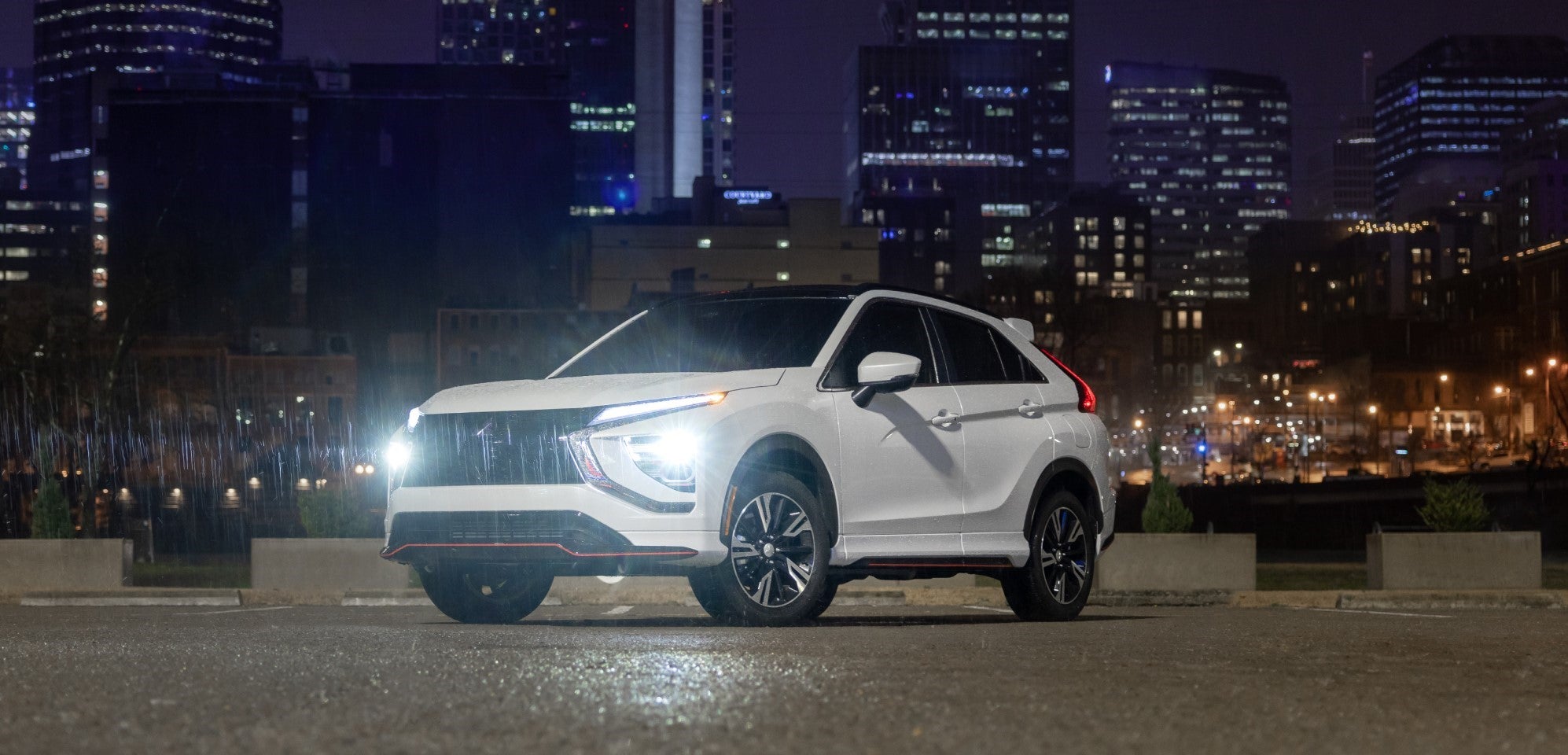 a blue mitsubishi eclipse cross driving on a winding paved road in the mountains
