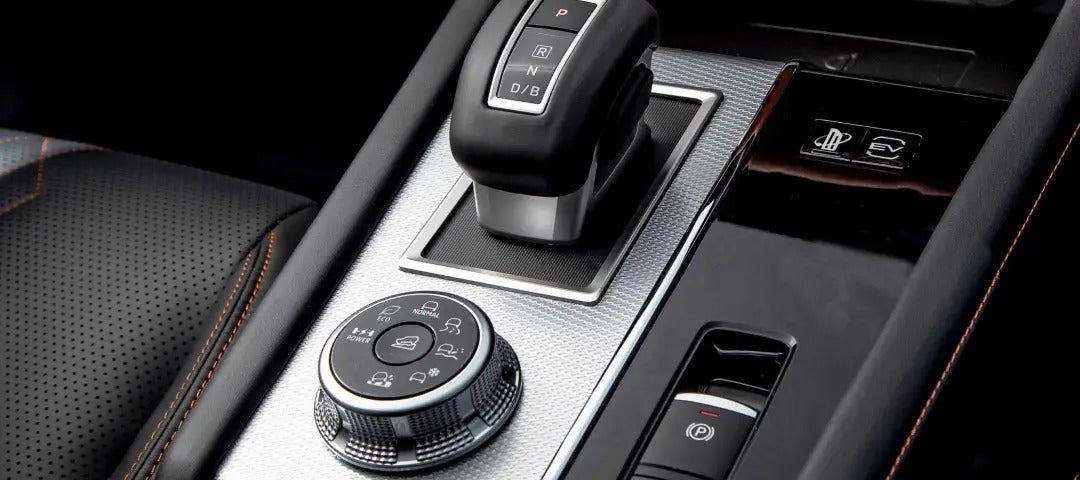 Close-up of the center console in the 2025 Mitsubishi Outlander PHEV, featuring the gear selector and drive mode control.