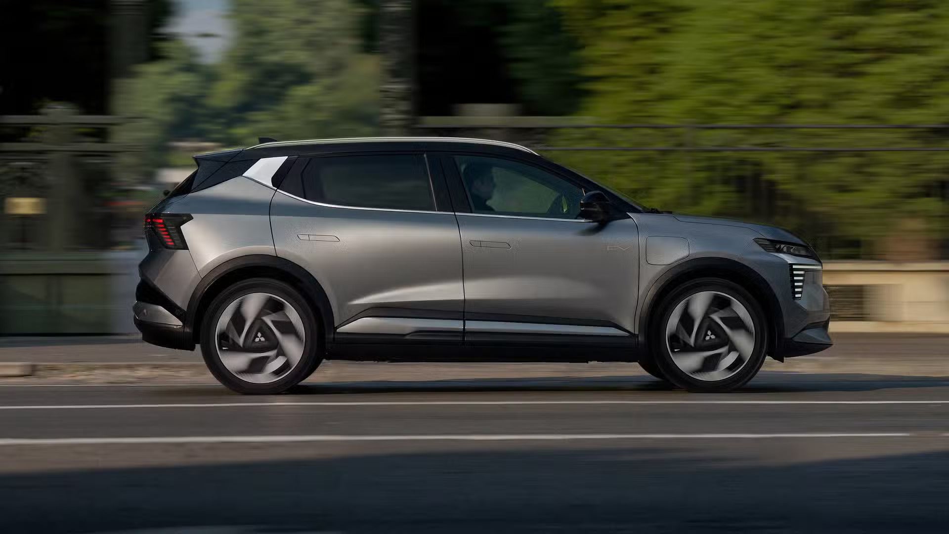 A grya suv driving on the road.