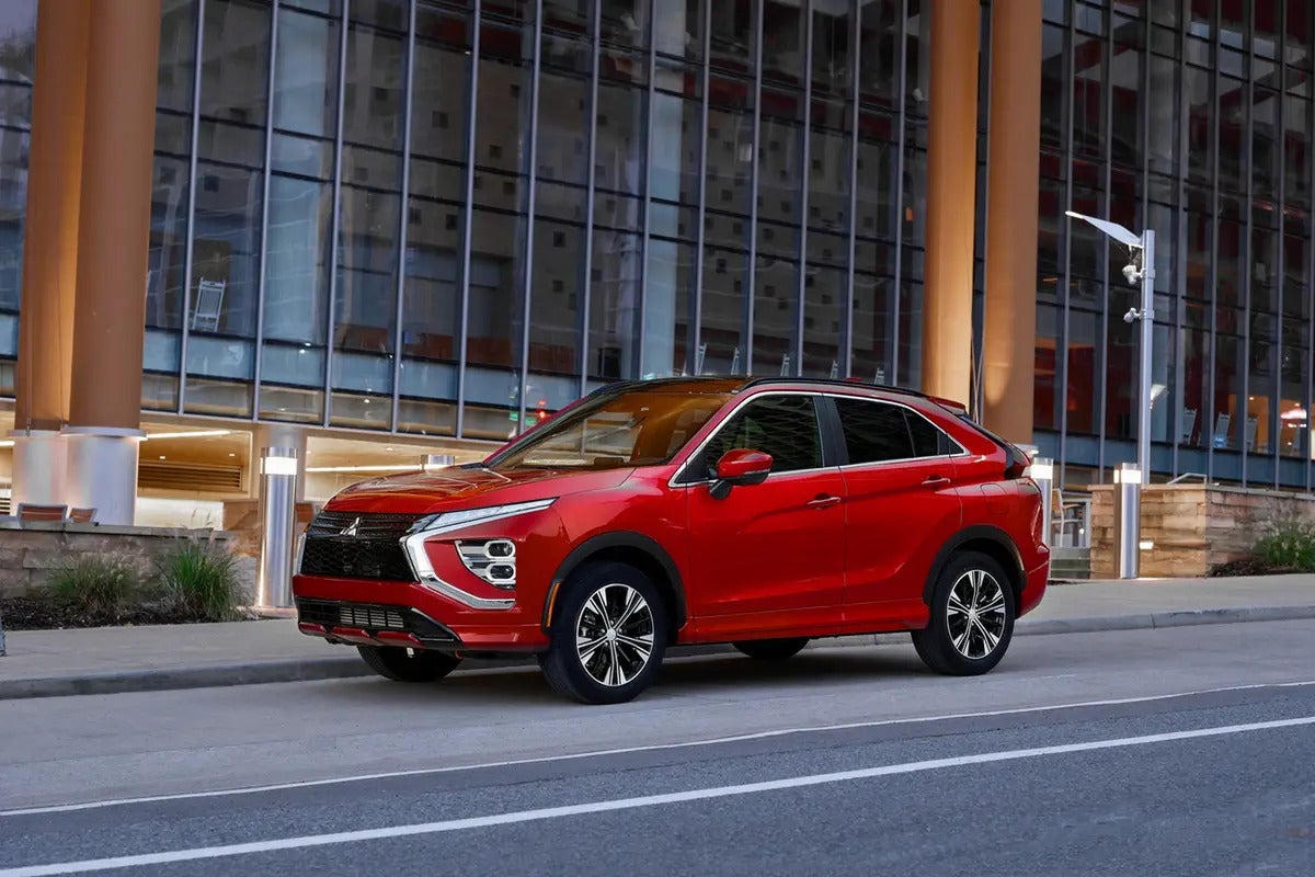 A red Eclipse Cross driving on the road.