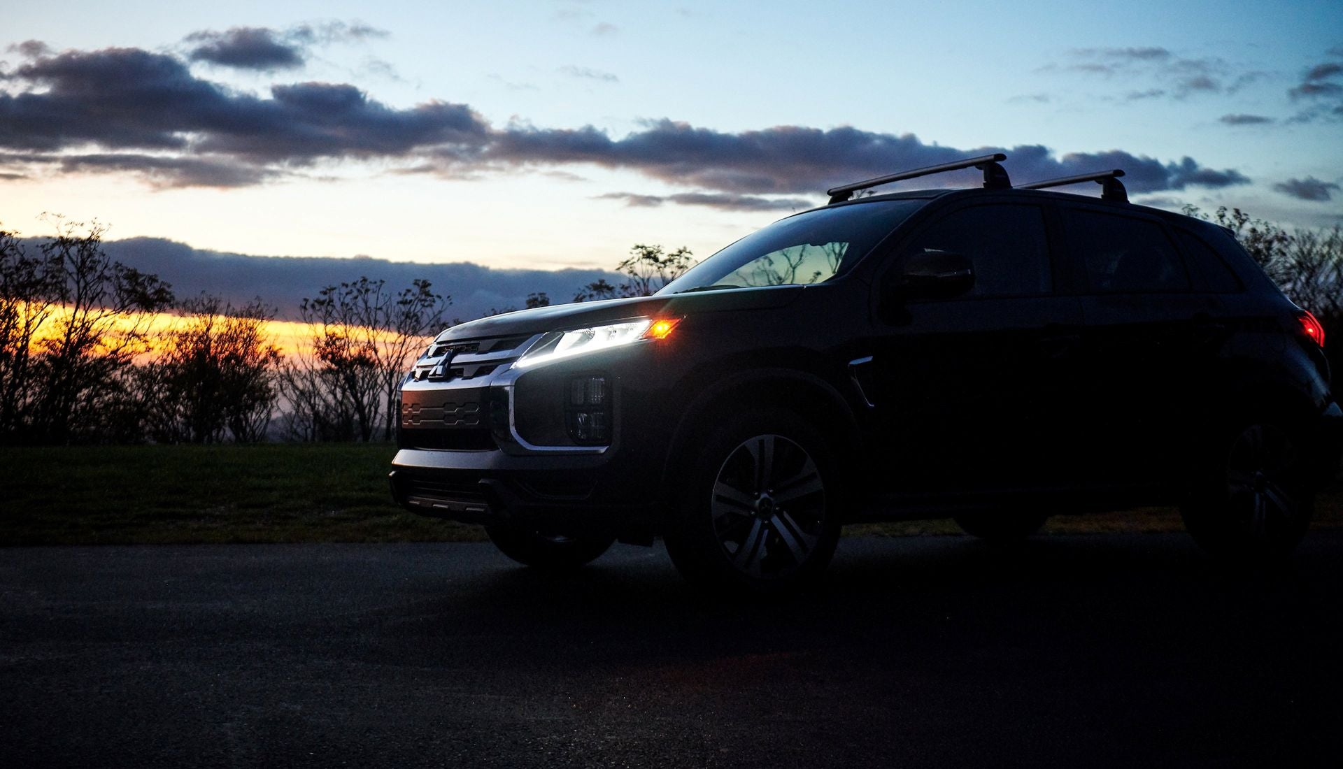 2026 Mitsubishi Outlander Sport parked on a road at night time