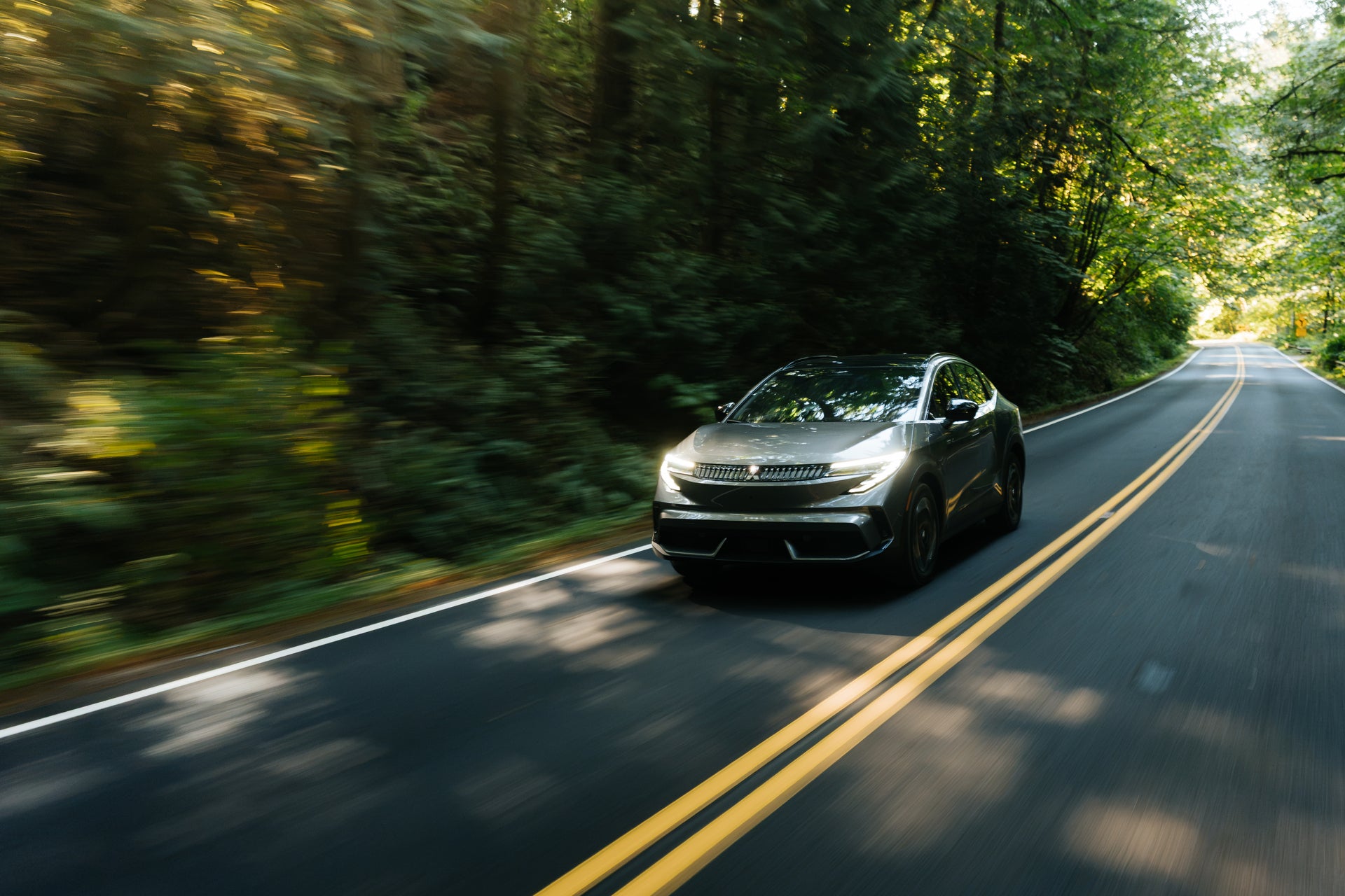 2027 Mitsubishi Eclipse Sportback EV driving on a West Texas road