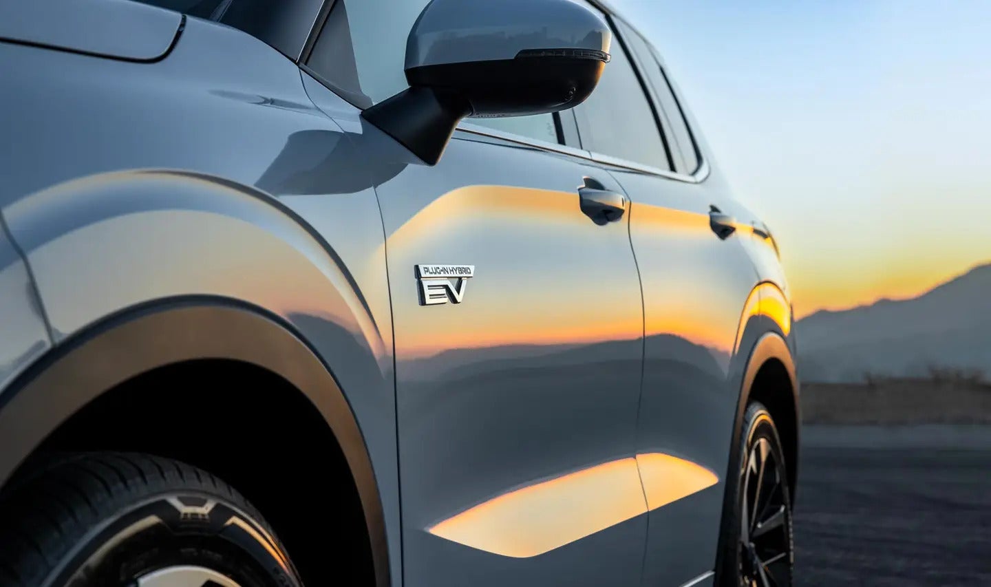 side profile of a white suv showing the plug-in hybrid ev logo