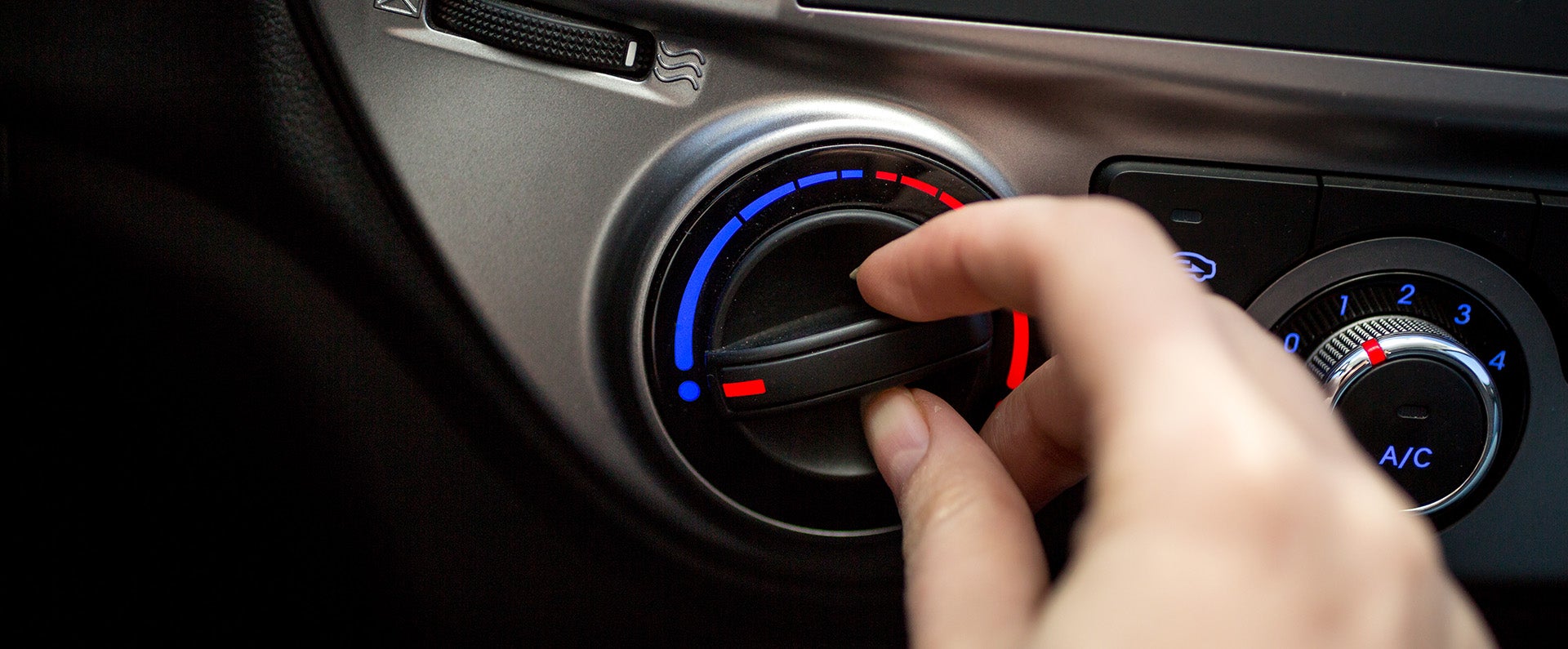 Arrow Mitsubishi technician repairing a Mitsubishi climate control system