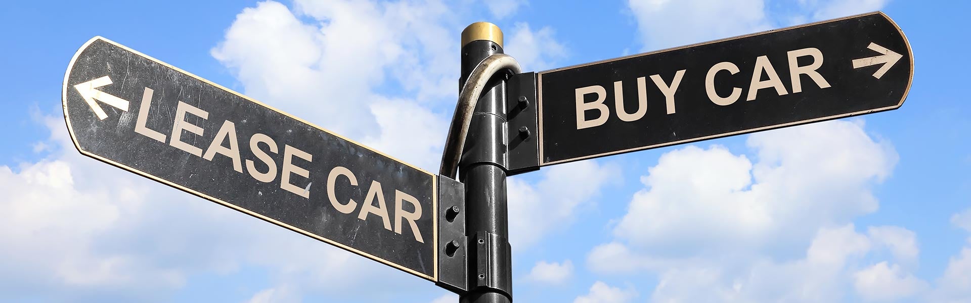 a street sign with lease and buy